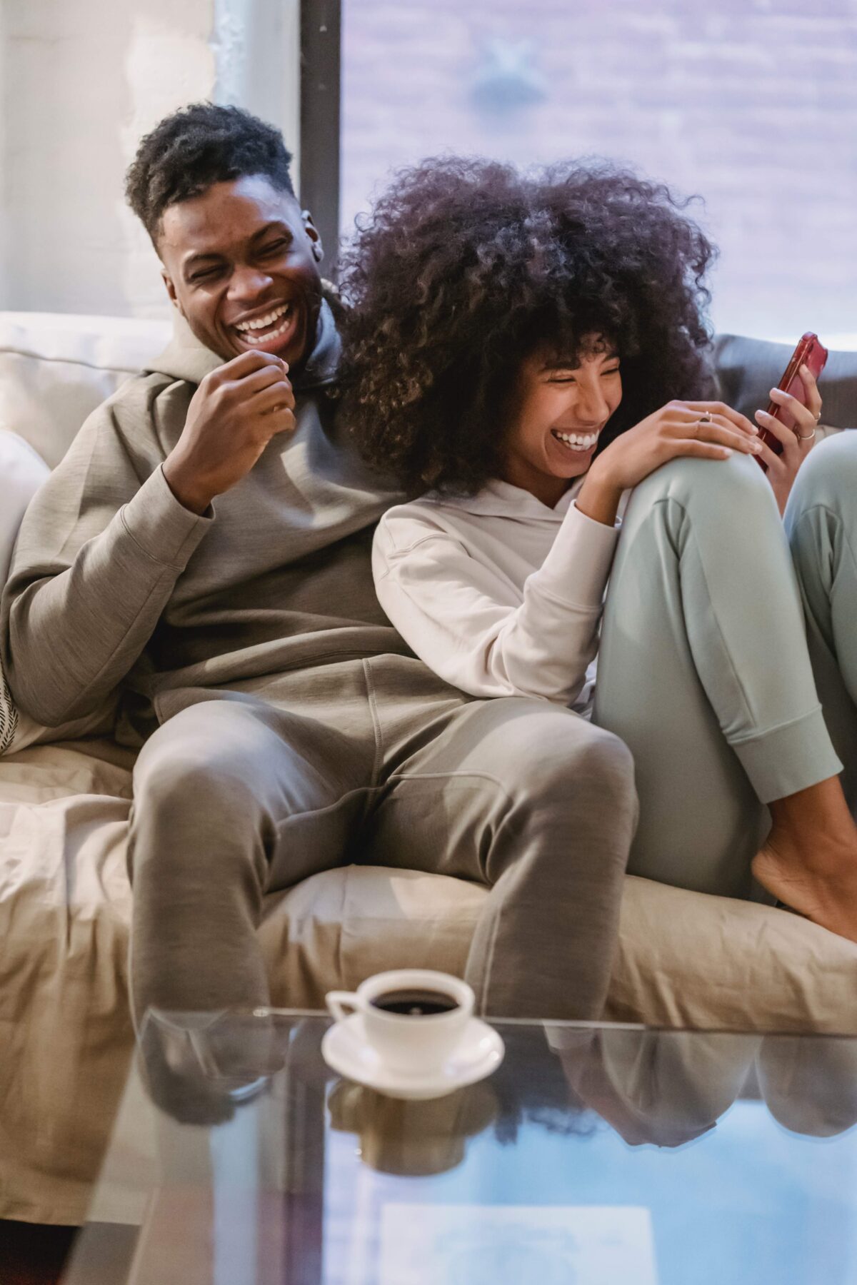 couple laughing on a couch