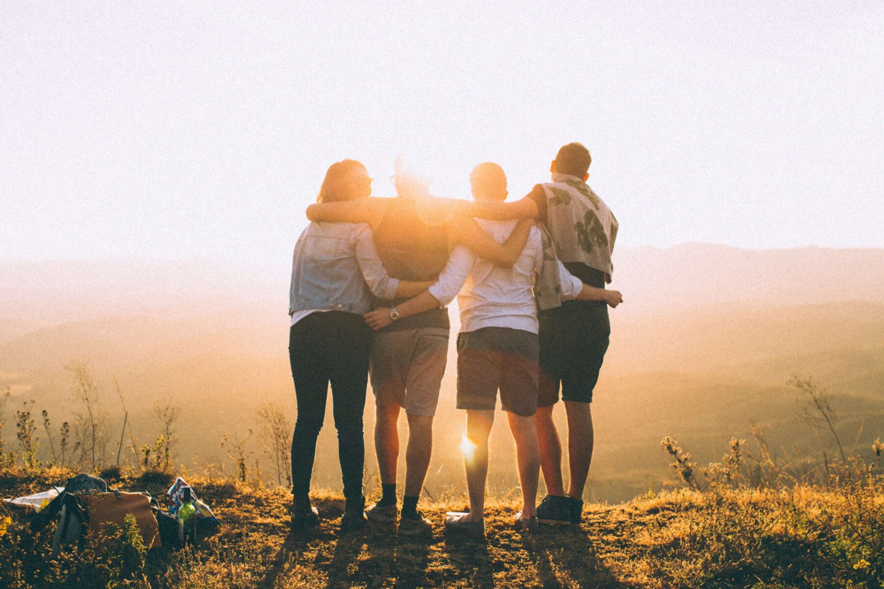 friends on a hike looking at a sunset