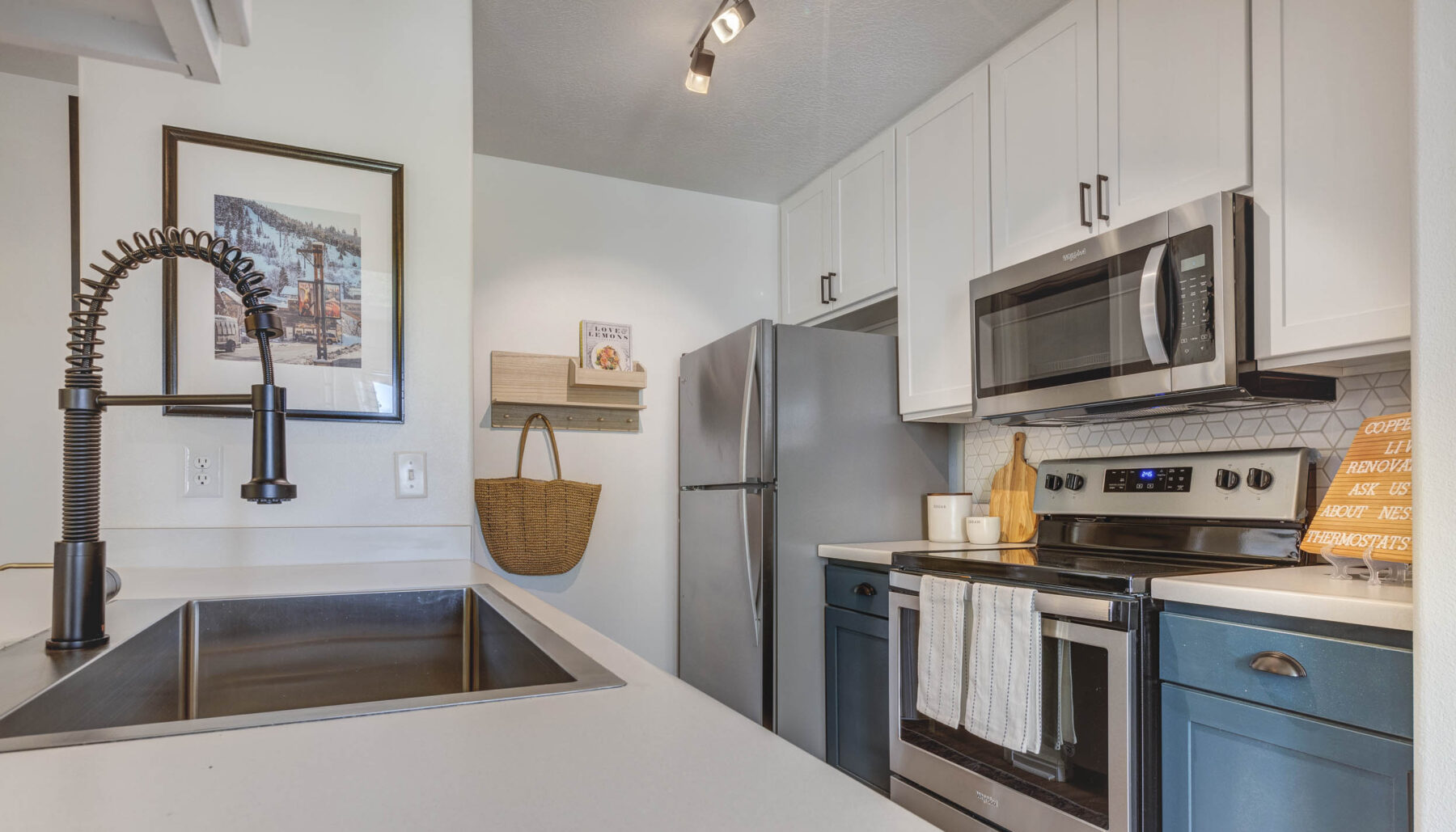 Kitchen with white wooden cabinets and stainless steel appliances